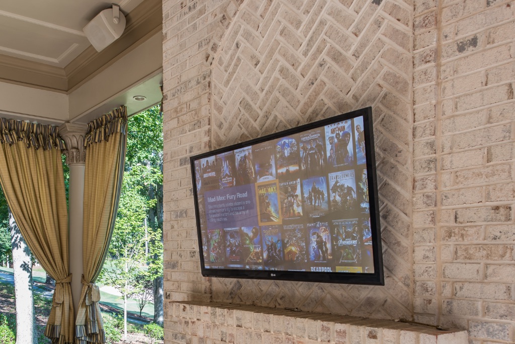 DLSAV outdoor patio TV on brick fireplace chimney